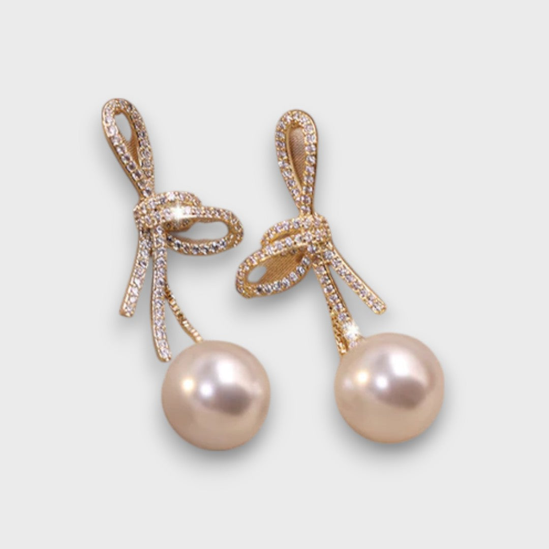 Celinea – Golden Bow Earrings with Radiant Pearl
